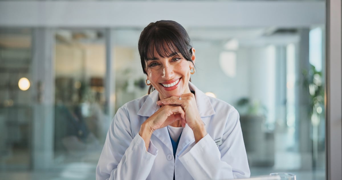 Confident Black female doctor in white coat smiling in modern hospital clinic